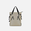 A Sherpani Tempest Straw Beige Convertible Tote, front view showing lockable pockets & straps against white background. #color_straw