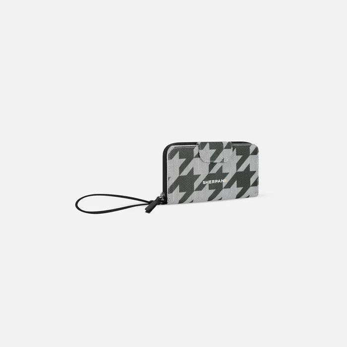 A Sherpani Tulum Houndstooth Anti-Theft Wallet, 3/4 view showing wrist strap and clasp on white background.  #color_houndstooth-print