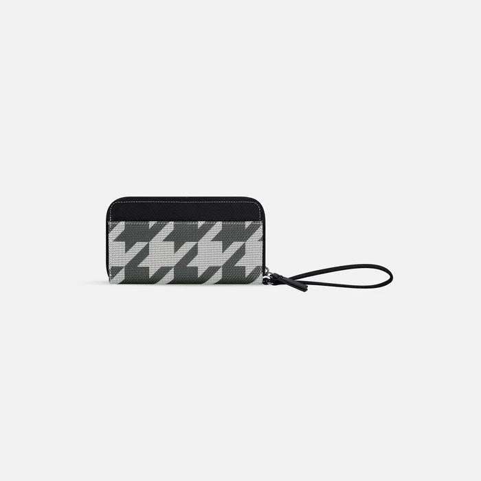 A Sherpani Tulum Houndstooth Anti-Theft Wallet, 3/4 view showing wrist strap and clasp on white background.  #color_houndstooth-print