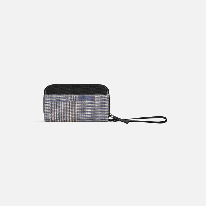 A Sherpani Tulum Passport Anti-Theft Wallet, back view showing wrist strap on white background. #color_passport-print