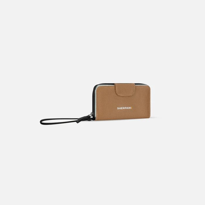 A Sherpani Tulum Sand Anti-Theft Wallet, 3/4 view showing wrist strap and clasp on white background.  #color_sand-tan