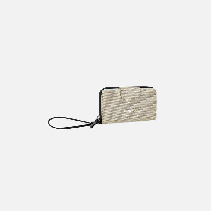 A Sherpani Tulum Straw Beige Anti-theft RFID Wallet, 3/4 view showing wrist strap on white backdrop. #color_straw-beige
