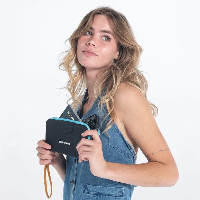 Woman holding a Sherpani Tulum Chromatic Black RFID Wallet against white background.   #color_chromatic-black