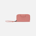 A Sherpani Tulum Desert Pink RFID Wallet, front view showing wrist strap and clasp on white background.#color_desert-pink