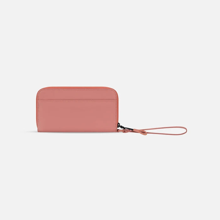 A Sherpani Tulum Desert Pink RFID Wallet, back view showing wrist strap on white background. #color_desert-pink