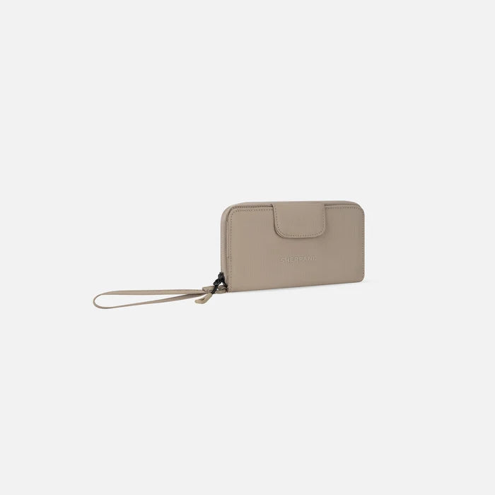 A Sherpani Tulum Dune RFID Wallet, 3/4 view showing wrist strap and clasp on white background.  #color_dune-tan