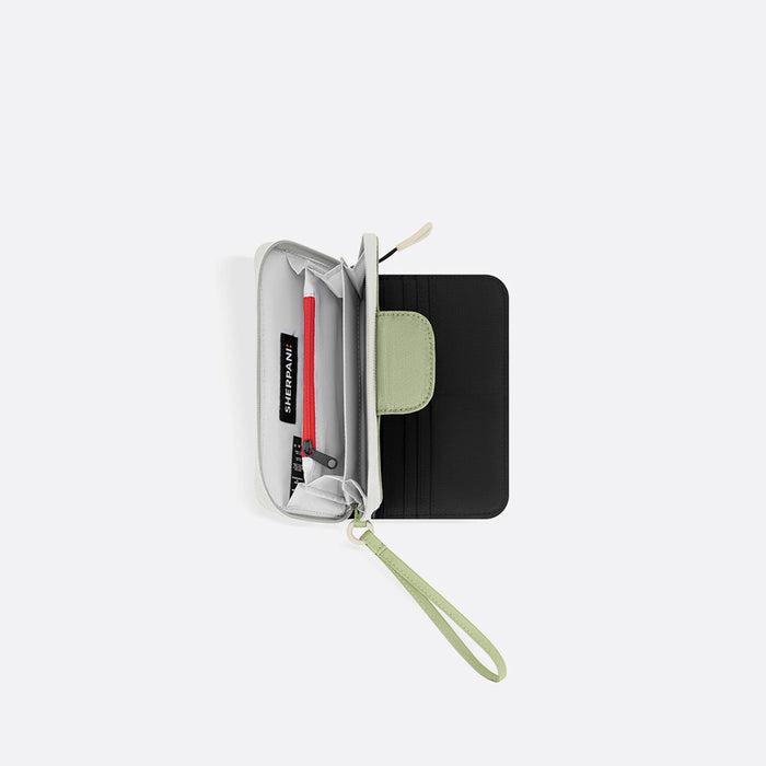 A Sherpani Tulum Palm Green RFID Wallet, above view showing inside of wallet on white backdrop. #color_palm-green