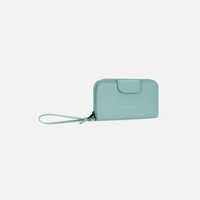 A Sherpani Tulum Surf Blue RFID Wallet, 3/4 view showing wrist strap and clasp on white background.  #color_surf-blue