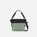 A Sherpani Vale Aloe Mist Green Anti-theft Reversible Crossbody, front view showing folded over front on white background. #color_aloe-mist-green