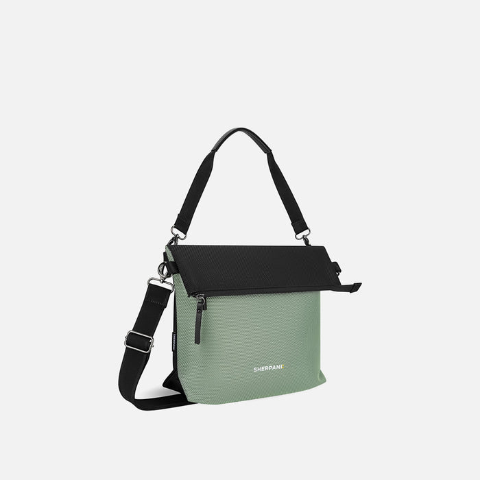 A Sherpani Vale Aloe Mist Green Anti-theft Reversible Crossbody, 3/4 view showing folded over front on white background. #color_aloe-mist-green
