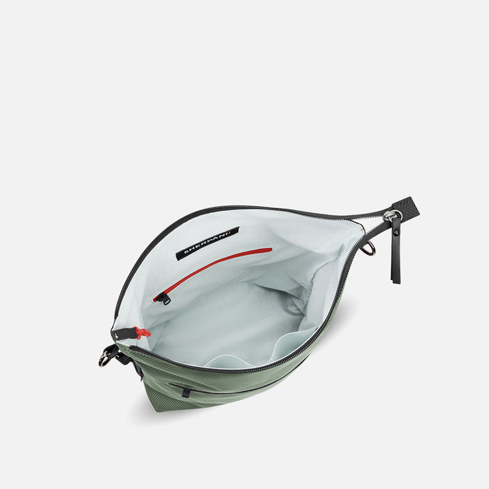 A Sherpani Vale Aloe Mist Green Anti-theft Reversible Crossbody, above view showing inside main pocket on white background. #color_aloe-mist-green