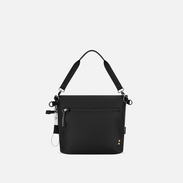 A Sherpani Vale Aloe Mist Green Anti-theft Reversible Crossbody, back view showing back lockable pocket on white background. #color_aloe-mist-green