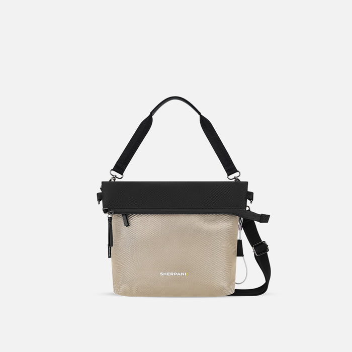 A Sherpani Vale Straw Beige Anti-theft Reversible Crossbody, front view showing folded over front on white background. #color_straw-beige