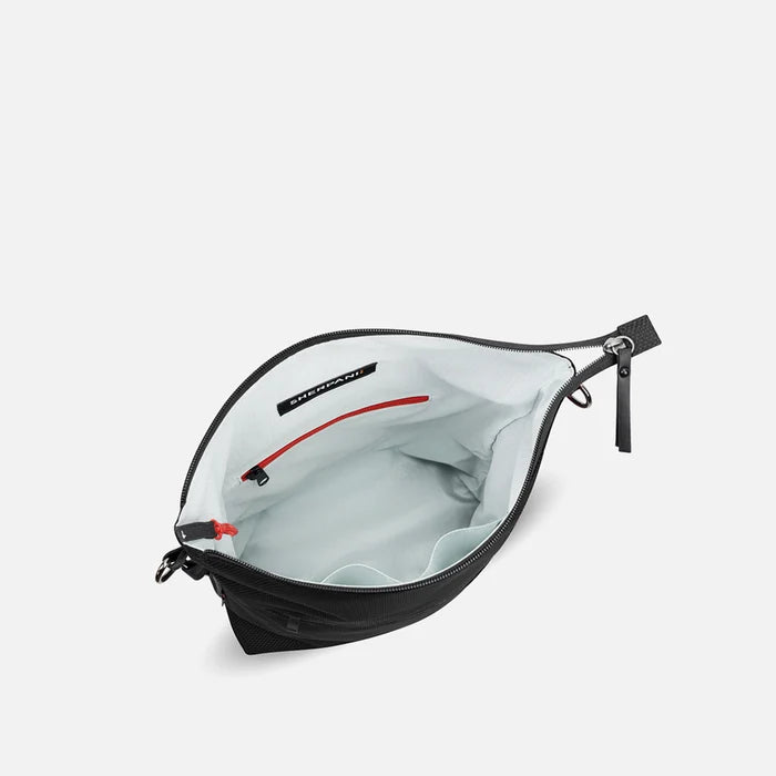 A Sherpani Vale Carbon Black Anti-theft Reversible Crossbody, above view showing inside of main pocket on white background.  #color_carbon-black