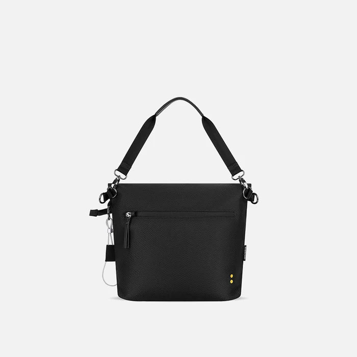A Sherpani Vale Carbon Black Anti-theft Reversible Crossbody, back view showing back lockable pocket on white background.  #color_carbon-black
