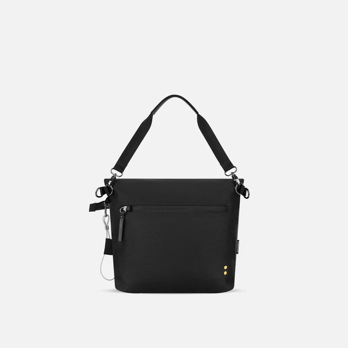 A Sherpani Vale Granite Anti-theft Reversible Crossbody, back view showing back lockable pocket on white background.  #color_granite-grey