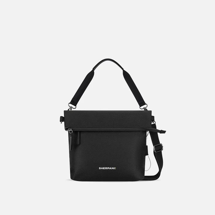 A Sherpani Vale Carbon Black Anti-theft Reversible Crossbody, front view showing folded over front on white background.  #color_carbon-black