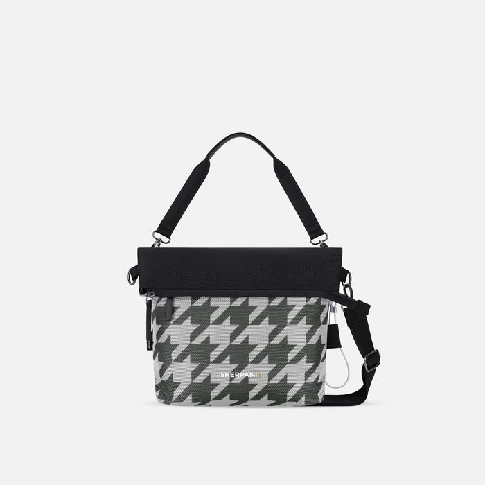 A Sherpani Vale Houndstooth Anti-theft Reversible Crossbody, front view showing folded over front on white background.  #color_houndstooth-print