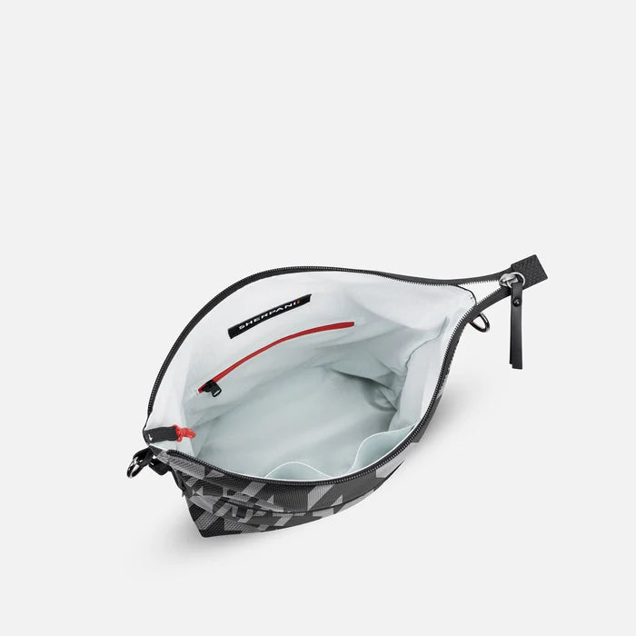 A Sherpani Vale Houndstooth Anti-theft Reversible Crossbody, above view showing inside of main pocket on white background.  #color_houndstooth-print