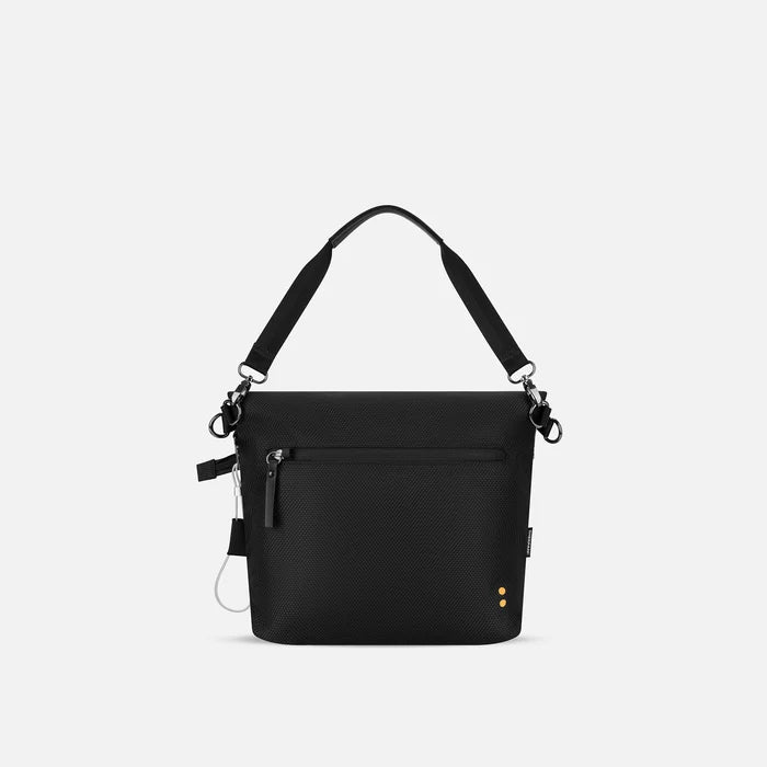 A Sherpani Vale Houndstooth Anti-theft Reversible Crossbody, back view showing back lockable pocket on white background.  #color_houndstooth-print