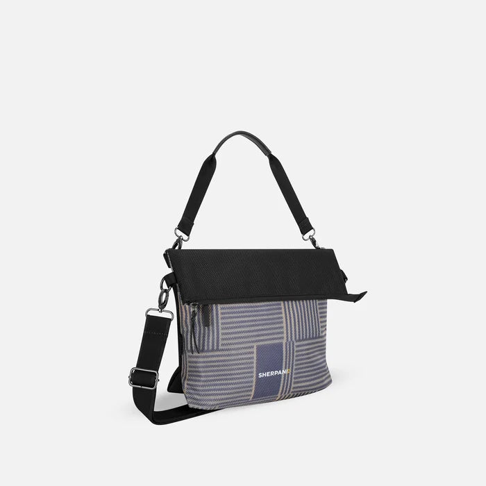 A Sherpani Vale Passport Anti-theft Reversible Crossbody, 3/4 view showing folded over front on white background.  #color_passport-print