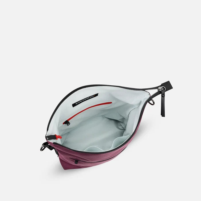 A Sherpani Vale Smoky Orchid Anti-theft Reversible Crossbody, above view showing inside of main pocket on white background.  #color_smoky-orchid-pink