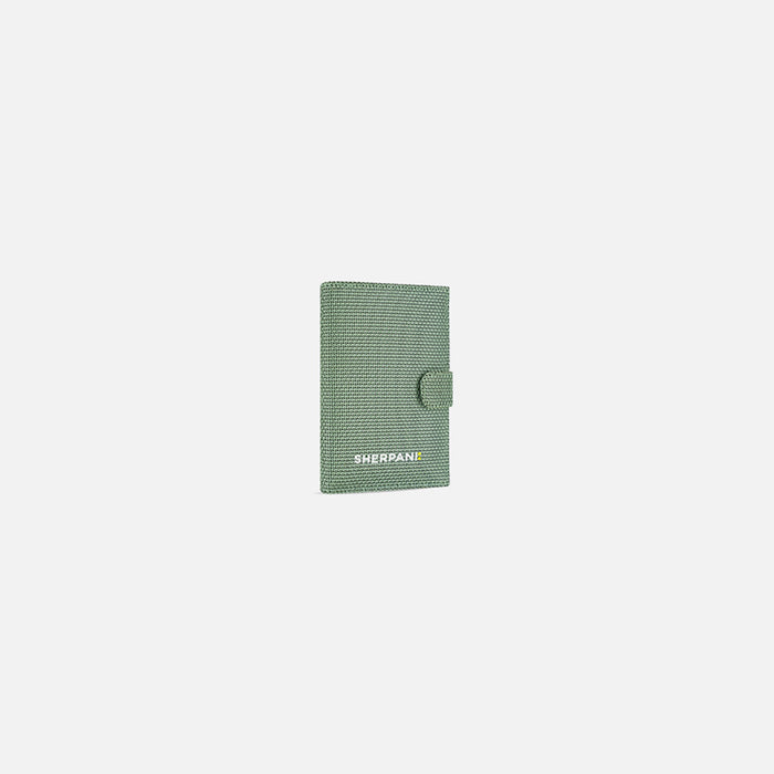 A Sherpani Vienna Aloe Mist Green Anti-theft Passport Wallet, 3/4 view against white background. #color_aloe-mist-green