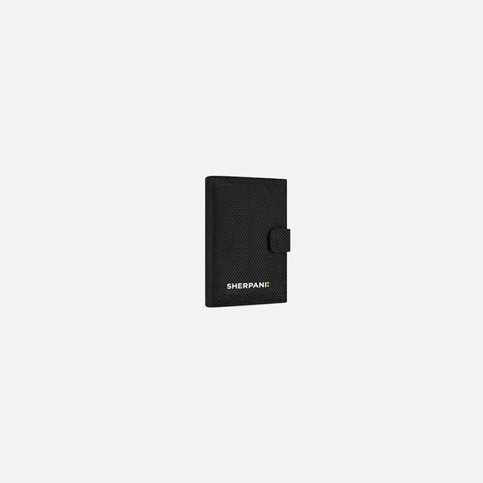 A Sherpani Vienna Carbon Black Anti-theft Passport Wallet, 3/4 view against white background.  #color_carbon-black
