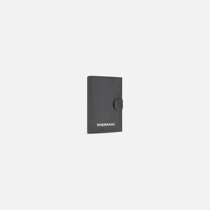 A Sherpani Vienna Granite Anti-theft Passport Wallet, 3/4 view against white background.  #color_granite-grey
