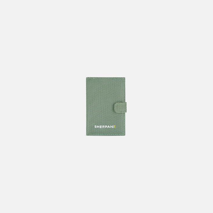 A Sherpani Vienna Aloe Mist Green Anti-theft Passport Wallet, front view against white background. #color_aloe-mist-green