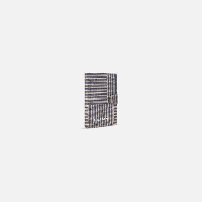 A Sherpani Vienna Passport Anti-theft Passport Wallet, 3/4 view against white background.  #color_passport-print