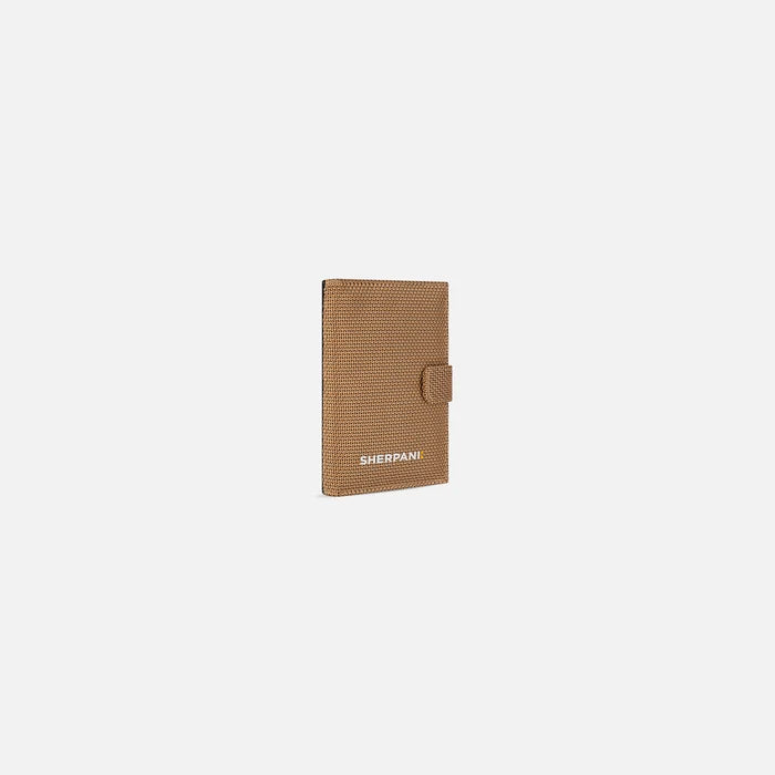 A Sherpani Vienna Sand Anti-theft Passport Wallet, 3/4 view against white background.  #color_sand-tan