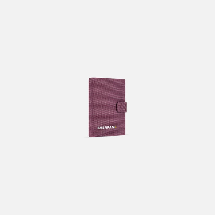 A Sherpani Vienna Smoky Orchid Anti-theft Passport Wallet, 3/4 view against white background.  #color_smoky-orchid-pink