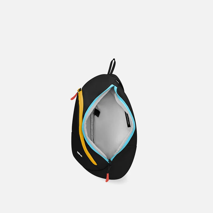 A Sherpani Wayfarer Chromatic Black Convertible Sling, above view showing inside of main pocket against white background.  #color_chromatic-black