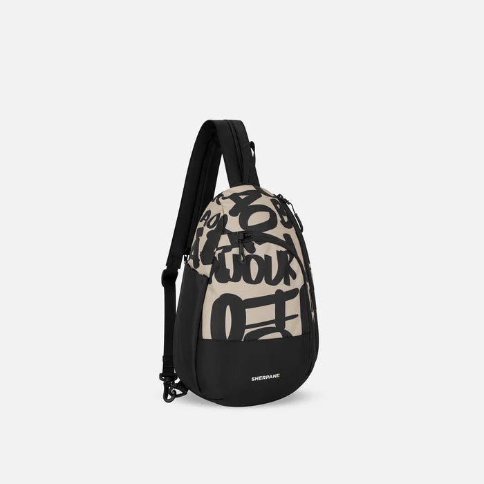 A Sherpani Wayfarer Ciao Convertible Sling, 3/4 view showing lockable pockets and main strap on white background. #color_ciao-print