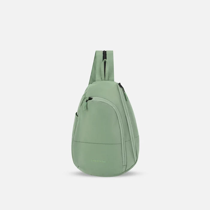 A Sherpani Wayfarer Olivine Convertible Sling, front view showing lockable pockets and main strap on white background. #color_olivine-green