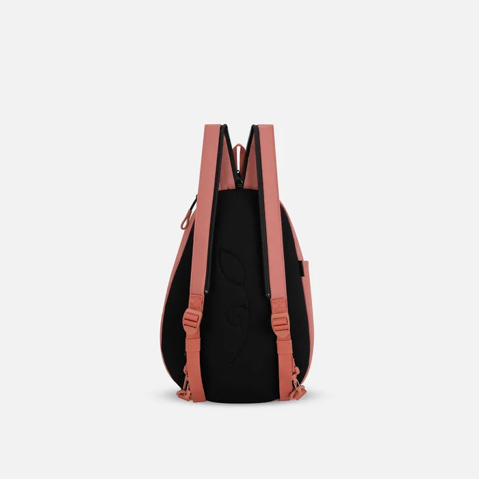 A Sherpani Wayfarer Desert Pink Convertible Sling, back view showing convertible strap against a white background.  #color_desert-pink