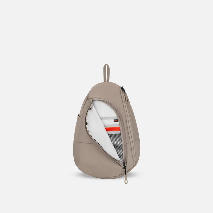 A Sherpani Wayfarer Dune Convertible Sling, front view showing inside pocket against white background.   #color_dune-tan