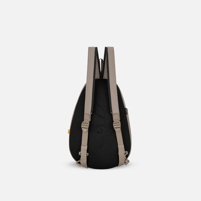 A Sherpani Wayfarer Dune Convertible Sling, back view showing convertible strap against a white background.  #color_dune-tan