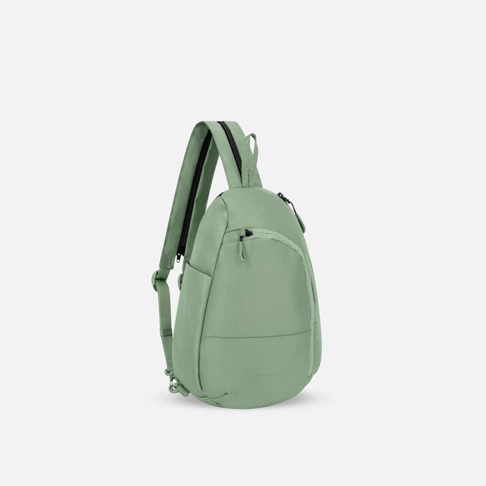 A Sherpani Wayfarer Olivine Convertible Sling, 3/4 view showing lockable pockets and main strap on white background. #color_olivine-green
