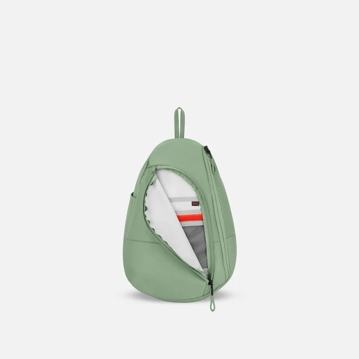 A Sherpani Wayfarer Olivine Convertible Sling, front view showing inside pocket against white background.   #color_olivine-green
