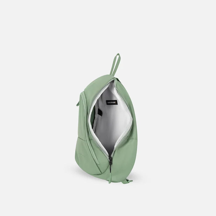 A Sherpani Wayfarer Desert Pink Convertible Sling, above view showing inside of main pocket against white background.  #color_olivine-green
