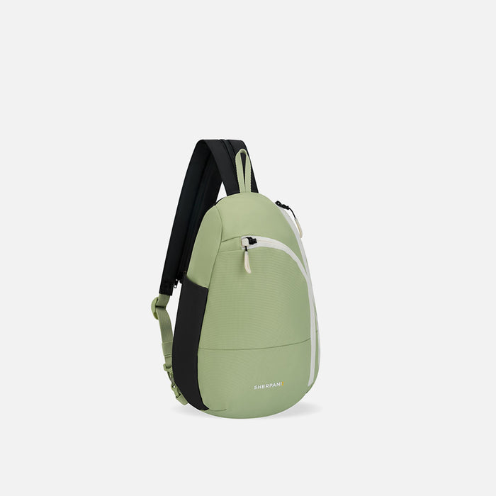 A Sherpani Wayfarer Palm Green Convertible Sling, 3/4 view showing lockable pockets and main strap on white background. #color_palm-green