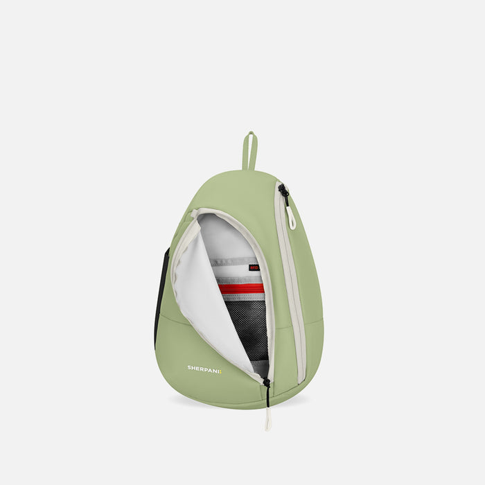 A Sherpani Wayfarer Palm Green Convertible Sling, front view showing inside of pocket against white background. #color_palm-green
