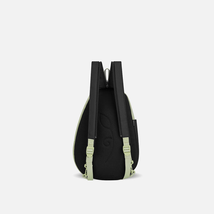 A Sherpani Wayfarer Palm Green Convertible Sling, back view showing convertible strap against a white background. #color_palm-green