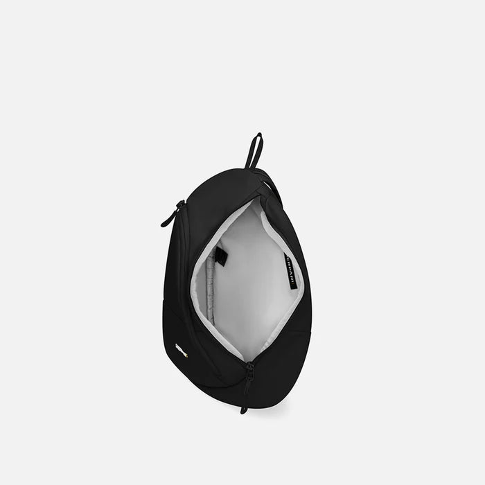 A Sherpani Wayfarer Raven Black Convertible Sling, above view showing inside of main pocket against white background.  #color_raven-black