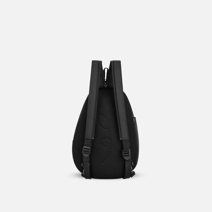 A Sherpani Wayfarer Raven Black Convertible Sling, back view showing convertible strap against a white background. #color_raven-black