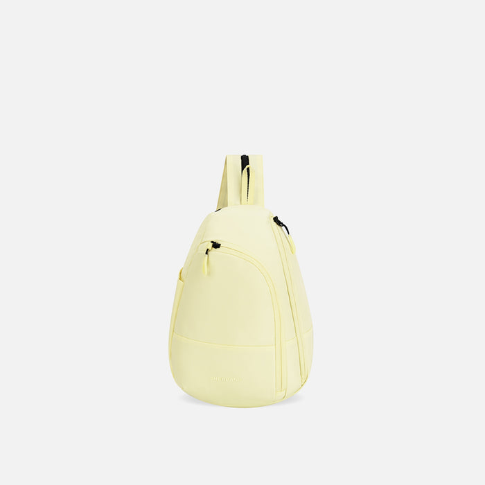 A Sherpani Wayfarer Sol Yellow Convertible Sling, front view showing lockable pockets and main strap on white background. #color_sol-yellow