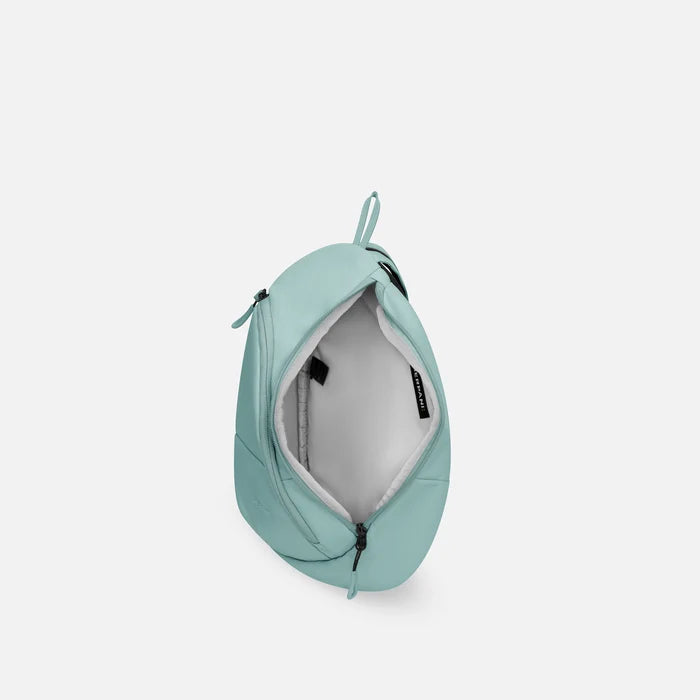 A Sherpani Wayfarer Surf Blue Convertible Sling, above view showing inside of main pocket against white background.  #color_surf-blue