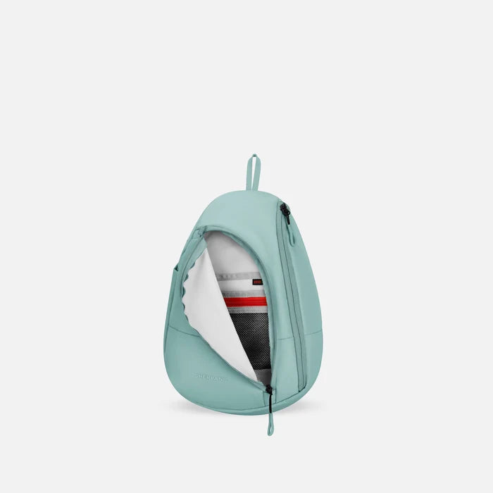 A Sherpani Wayfarer Surf Blue Convertible Sling, front view showing inside pocket against white background.   #color_surf-blue